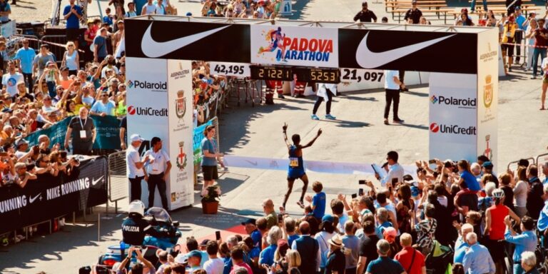 Runner completing a race and crossing the finish line in first place