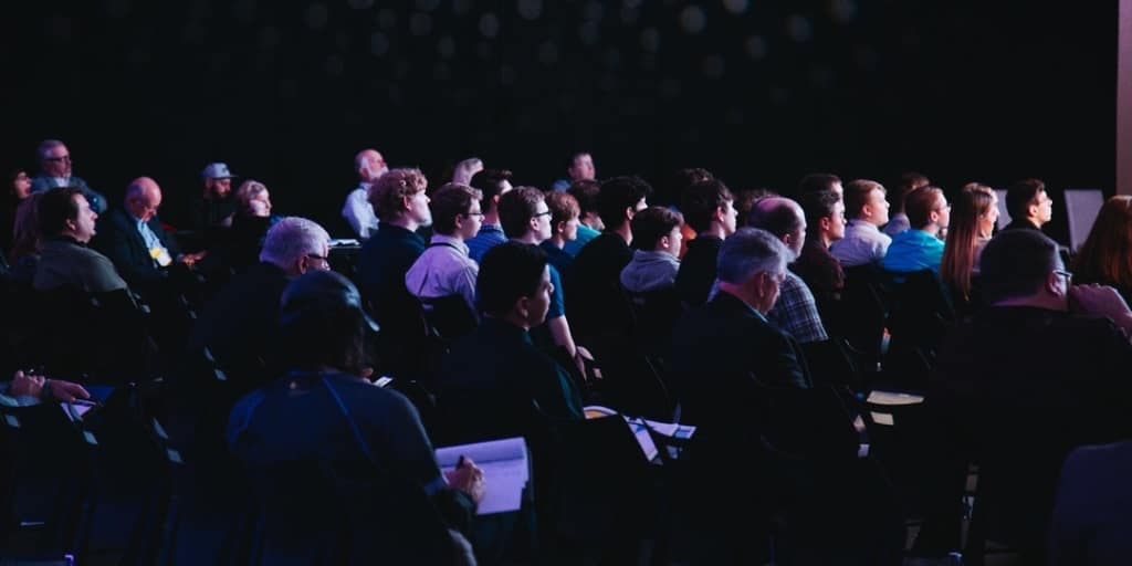 Audience watching a keynote speaker during a conference