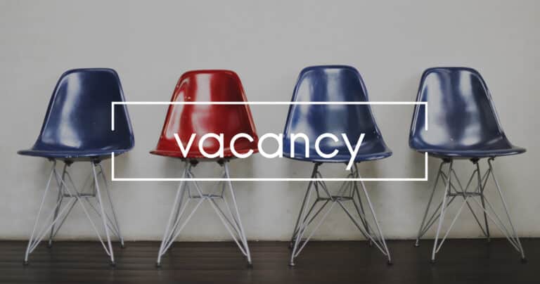 Row of 4 empty chairs with the word vacancy splashed across them