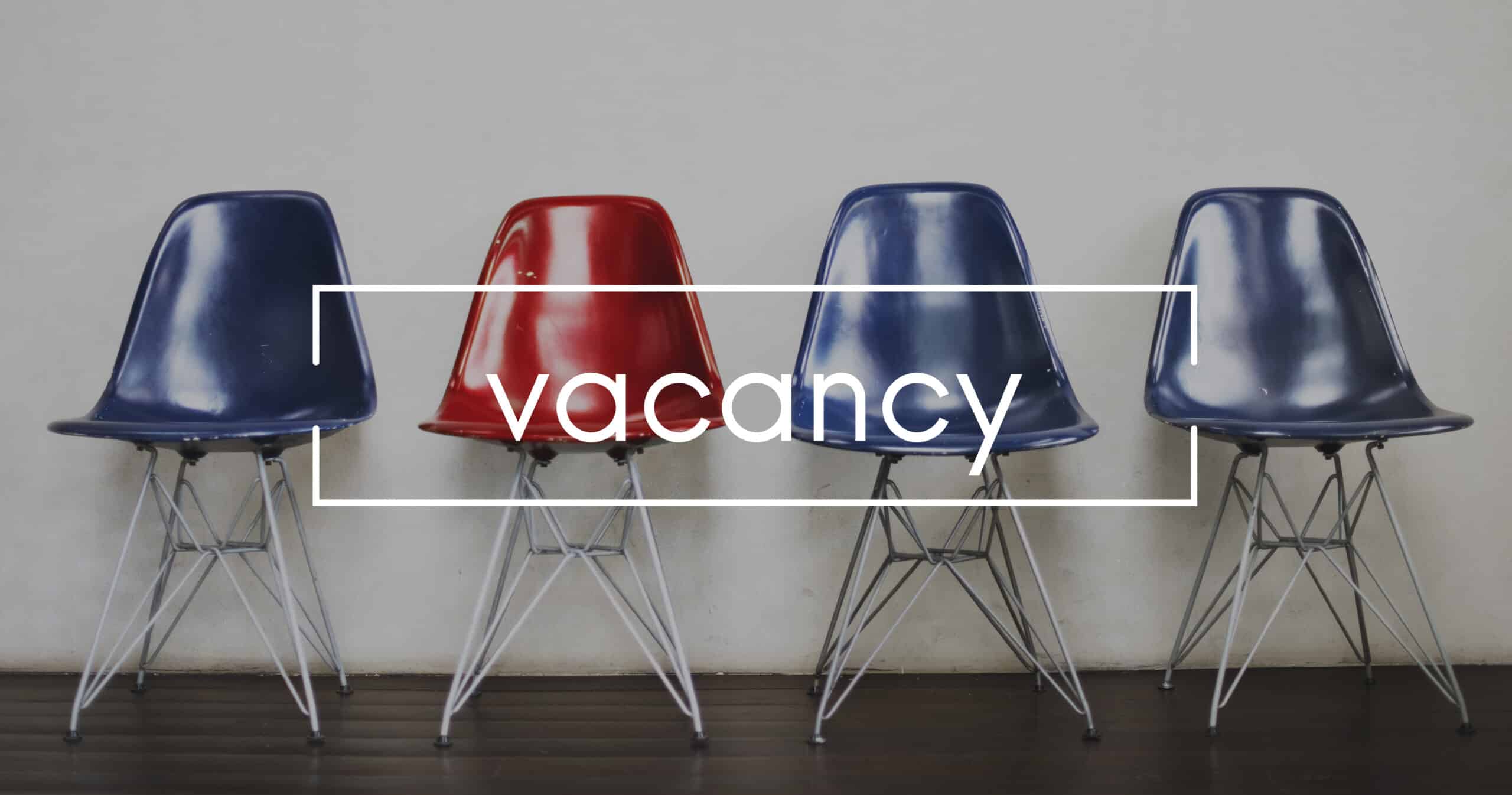 Row of 4 empty chairs with the word vacancy splashed across them