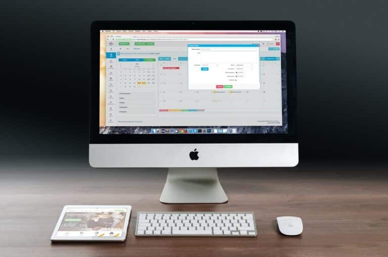 An image of a Mac computer with a scheduling software displaying on the screen