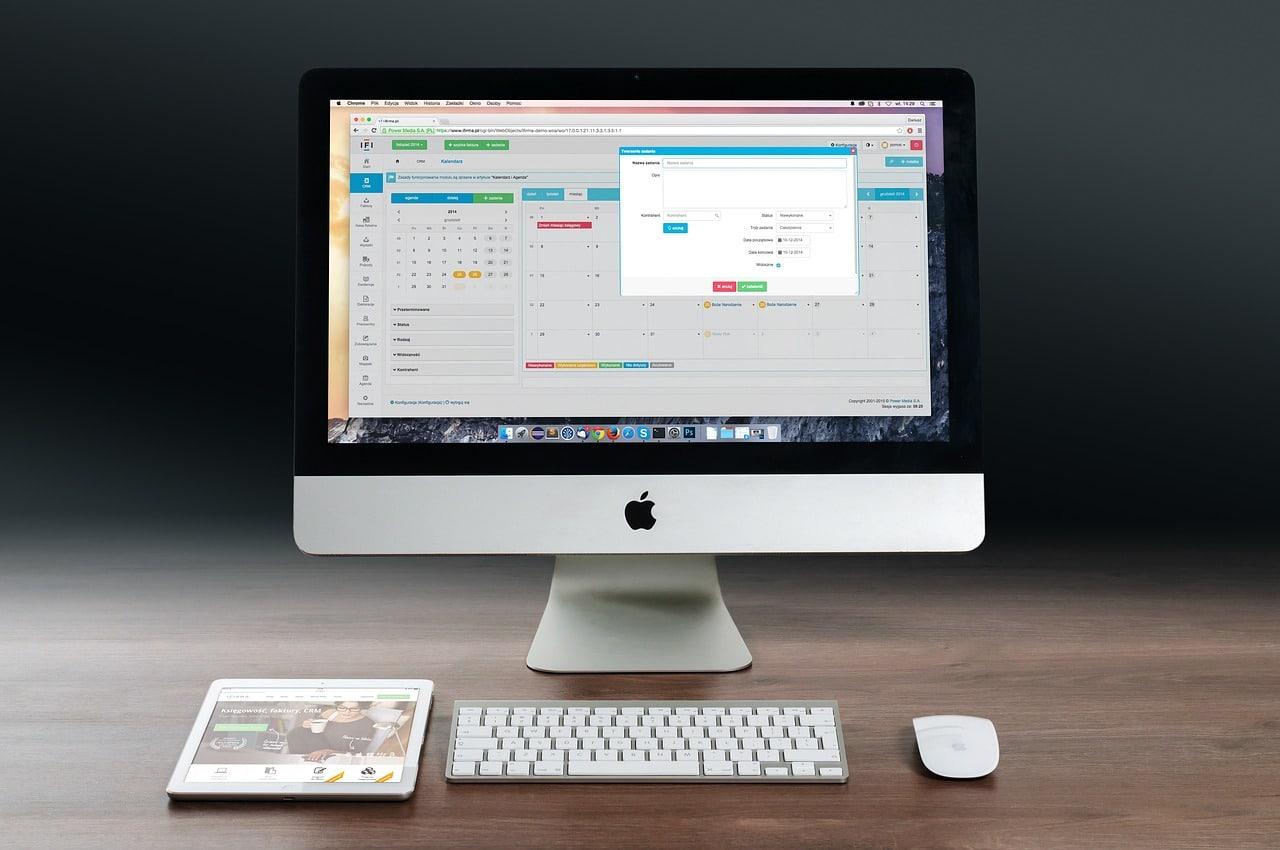 An image of a Mac computer with a scheduling software displaying on the screen